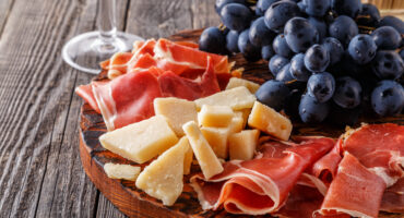 Prosciutto,,Wine,,Grape,,Parmesan,On,Wooden,Table,,Selective,Focus.