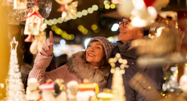 senior couple at christmas market souvenir shop