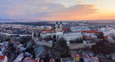 Veszprém, Hungary - Amazing aerial view of Veszprém downtown and castle district on a winter morning with stunning golden sunrise. Historical old buildings, church and much more.